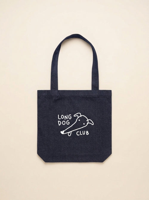 Denim tote bag with 'Long Dog Club' text and greyhound drawing on a beige background