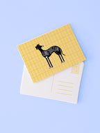 Yellow checkered postcard with a black dog illustration and 'Long Dog Club' text on a light blue background.