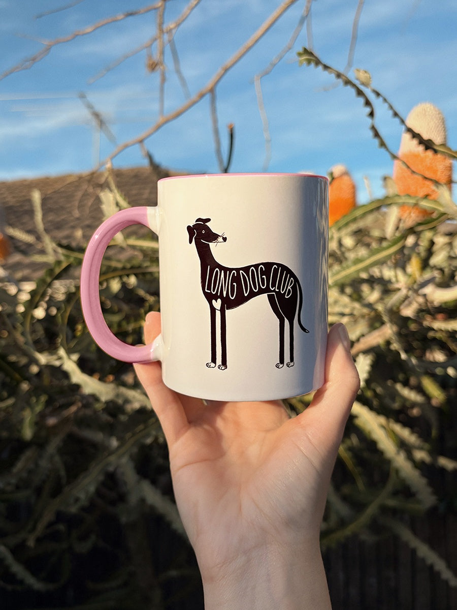 Holding a pink greyhound mug outside in the sunshine