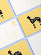 Postcards with black dog illustrations and 'Long Dog Club' text on a yellow and white checkered background.