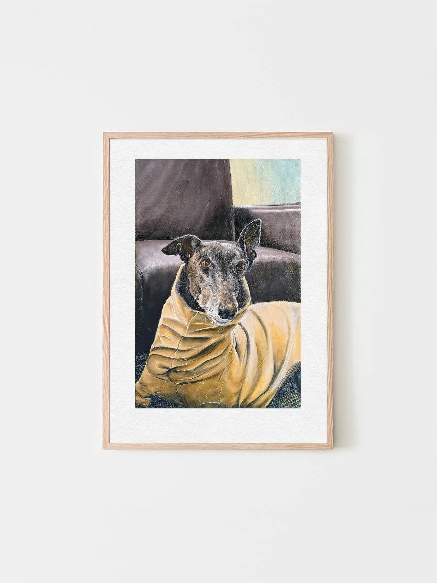 A framed custom pet portrait of a black greyhound dog called Winston wearing a yellow turtleneck jumper. He looks very handsome and has his ears up as he gazes towards his owner. 