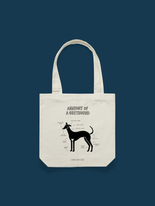 Tote bag with 'Anatomy of a Greyhound' design on a dark blue background from Long Dog Club